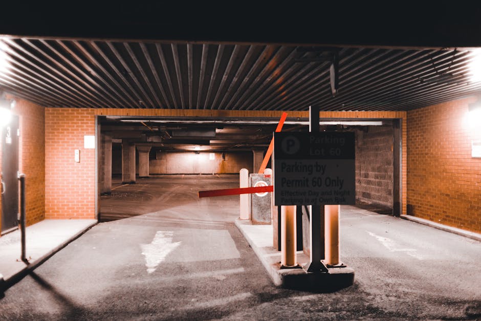 A row of four black loading bay shutters with white labelings B56, B57, B58, and B59 are mounted on a bright yellow exterior wall of a commercial building. Each shutter is partially lowered into a met